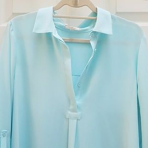 Turquoise colored high low vneck light shirt.